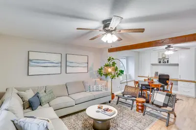 a living room with a couch and a ceiling fan at Mid-Century Mod Cottage, Steps to Lake Gregory! in Crestline