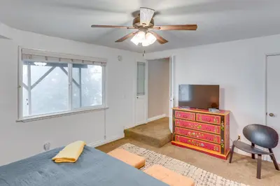 a bedroom with a ceiling fan and a dresser at Mid-Century Mod Cottage, Steps to Lake Gregory! in Crestline
