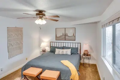a bedroom with a bed and a ceiling fan at Mid-Century Mod Cottage, Steps to Lake Gregory! in Crestline