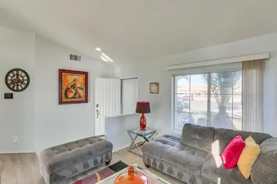a living room with a couch and a window at Victorville Home with Fenced Backyard and Patio! in Victorville