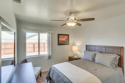 a bedroom with a bed and a ceiling fan at Victorville Home with Fenced Backyard and Patio! in Victorville