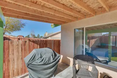 a patio with a chair and a fence at Victorville Home with Fenced Backyard and Patio! in Victorville
