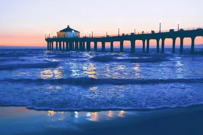 a pier in the water with the ocean at Brand New Ocean-View Beach Home Steps to the Sand! in Manhattan Beach