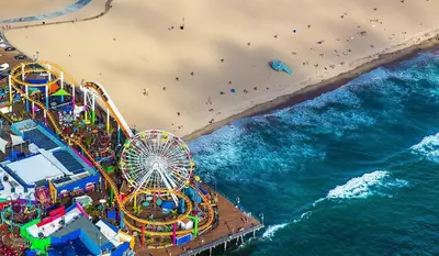 an overhead view of a beach with a roller coaster at 2 Santa Monica Beach Walking in Los Angeles