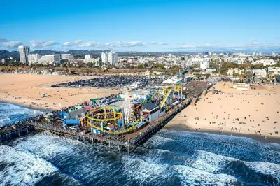 an aerial view of a beach with a roller coaster at 2 Santa Monica Beach Walking in Los Angeles