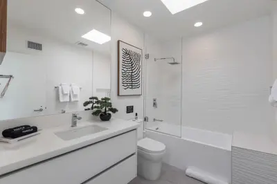 a bathroom with a sink and a toilet and a shower at Malibu Breeze - hot tub, ocean view, steps to beach in Malibu