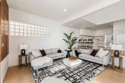 a living room with two couches and a rug at Malibu Breeze - hot tub, ocean view, steps to beach in Malibu