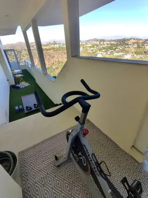 a bike parked in a room with a window at Epic Views! Hollywood Hills SkyVilla: Crow's Nest in Los Angeles