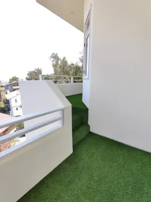 a room with green flooring on a balcony at Epic Views! Hollywood Hills SkyVilla: Crow's Nest in Los Angeles