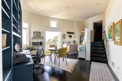 a kitchen and living room with a table and chairs at Epic Views! Hollywood Hills SkyVilla: Crow's Nest in Los Angeles