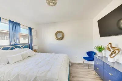 a bedroom with a blue bed and a blue chair at Los Angeles Townhome Off-Street Parking and Balcony in Los Angeles