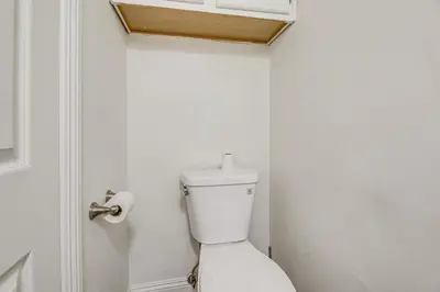 a white bathroom with a toilet in a room at Los Angeles Townhome Off-Street Parking and Balcony in Los Angeles