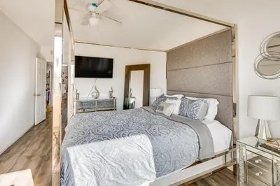 a bedroom with a large bed with a large mirror at Los Angeles Townhome Off-Street Parking and Balcony in Los Angeles