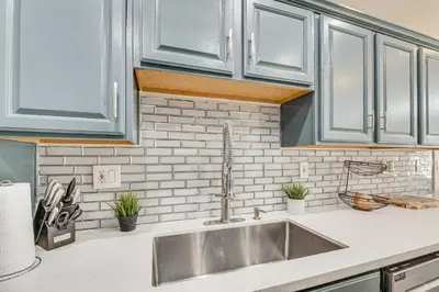 a kitchen with a sink and white cabinets at Los Angeles Townhome Off-Street Parking and Balcony in Los Angeles