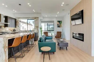 a kitchen and living room with a bar and a couch at Brand New Modern 5 Bedroom House Pickfair Village in Los Angeles