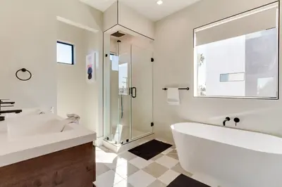 a white bathroom with a tub and a sink at Brand New Modern 4 Bedroom House Pickfair Village in Los Angeles