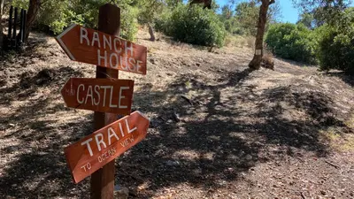 a pole with street signs on a dirt road at Malibu Ranch Guest House Hideway in Malibu