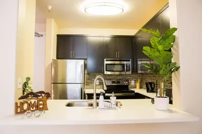 a kitchen with a sink and a stainless steel refrigerator at Charming & Peaceful l 1 bedroom in Marina Del Rey, CA in Los Angeles