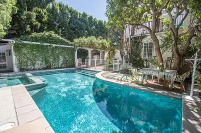 a swimming pool in front of a house at Beverly Hills Celebrity Home in Los Angeles