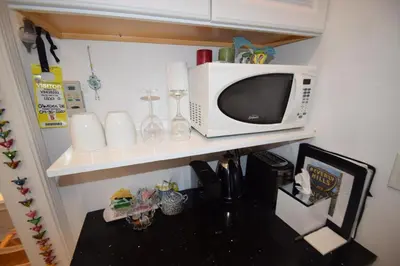 a microwave sitting on top of a shelf at Beverly Hills Celebrity Home in Los Angeles