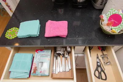 a black counter top with utensils on it at Beverly Hills Celebrity Home in Los Angeles