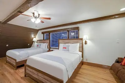 a bedroom with two beds and a ceiling fan at Arrowhead Tree Top Lodge in Lake Arrowhead