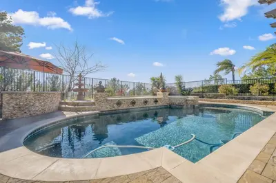 a swimming pool in a yard with a fence at ৎ୭The safty paradiseৎ୭ H/w Pool Jacuzzi &much more in Los Angeles