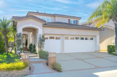 a house with a white garage and palm trees at ৎ୭The safty paradiseৎ୭ H/w Pool Jacuzzi &much more in Los Angeles