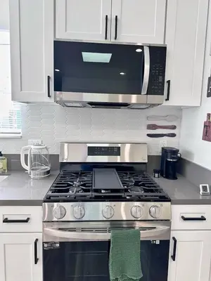 a kitchen with a stove and a microwave at New built house in Los Angeles! in Los Angeles