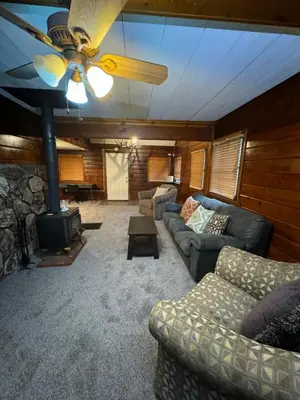 a living room with a couch and a fireplace at Crest Lodge Historic Mountain Inn in Crestline