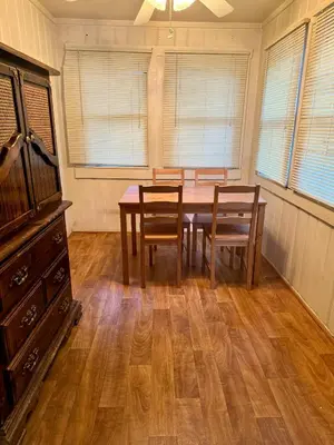 a dining room with a wooden table and chairs at Crest Lodge Historic Mountain Inn in Crestline