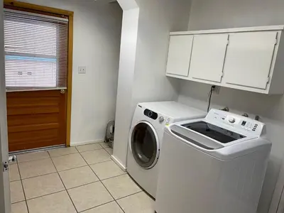 a white washer and dryer in a small kitchen at Snow Bear Lodge in Big Bear Lake