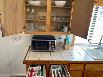 a kitchen counter with a microwave on top of it at Snow Bear Lodge in Big Bear Lake