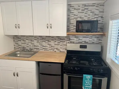 a kitchen with a stove and a sink and a microwave at Snow Bear Lodge in Big Bear Lake