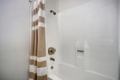 a bathroom with a shower with a shower curtain at Blueground Fairfax pool nr mall dining LAX-1185 in Los Angeles