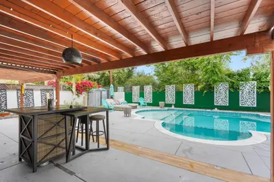 a patio with a table and a swimming pool at Valley Glen Getaway in Van Nuys