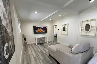 a living room with a couch and a table at Valley Glen Getaway in Van Nuys