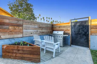 a patio with two chairs and a table and a stove at Peace palace in Los Angeles
