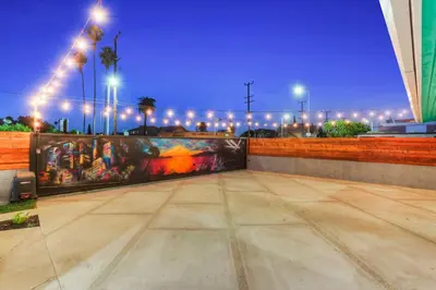 a painting on the side of a wall at night at Peace palace in Los Angeles
