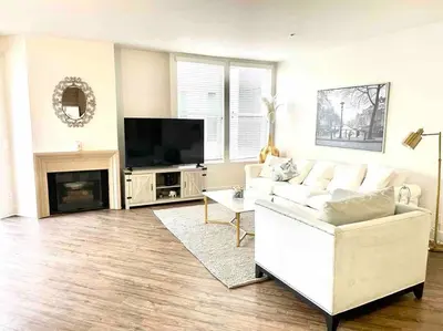 a living room with a white couch and a tv at Spacious 2 Bedroom Venice Beach Villa in Los Angeles