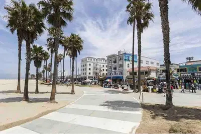 a street with palm trees and buildings on a beach at Spacious 2 Bedroom Venice Beach Villa in Los Angeles