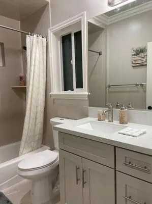 a bathroom with a toilet and a sink at New! Modern Gated Summer Getaway Home in Rosemead