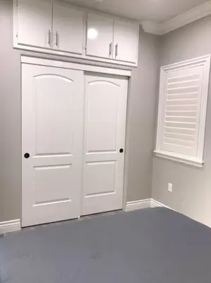 a white kitchen with white cabinets and a window at New! Modern Gated Summer Getaway Home in Rosemead