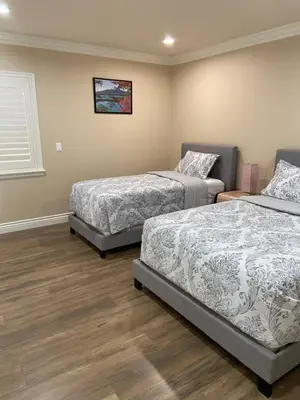 a bedroom with two beds and a window at New! Cozy Gated 3BR, 2BA Vacation Home in Rosemead
