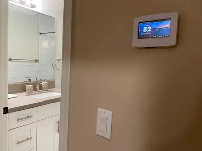 a bathroom with a television hanging on the wall at New! Cozy Gated 3BR, 2BA Vacation Home in Rosemead