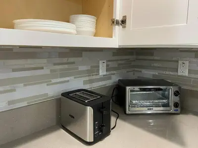 a toaster and a toaster oven sitting on a kitchen counter at New! Cozy Gated 3BR, 2BA Vacation Home in Rosemead