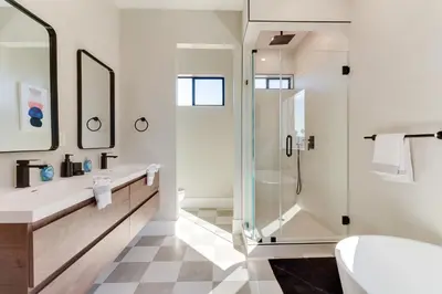 a bathroom with a glass shower and a toilet at Brand New Modern 9 Bedroom Compound in Pickfair Village in Los Angeles