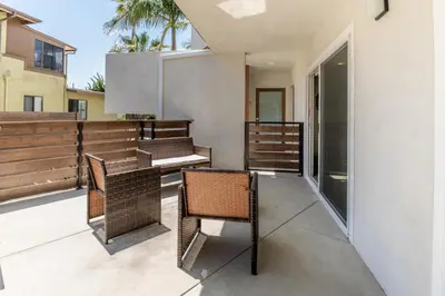 a balcony with wicker chairs and a table at Redondo Beach 2br walk to shops restaurants LAX-1166 in Torrance