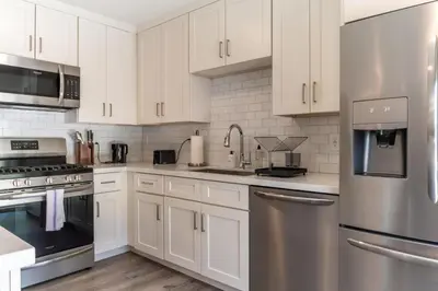 a kitchen with white cabinets and stainless steel appliances at Redondo Beach 2br walk to shops restaurants LAX-1166 in Torrance