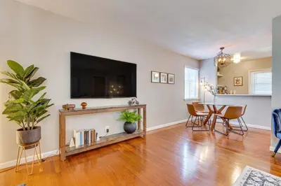 a living room with a tv and a table with chairs at 1 Mi to Shopping and Dining Central Burbank Duplex in Burbank